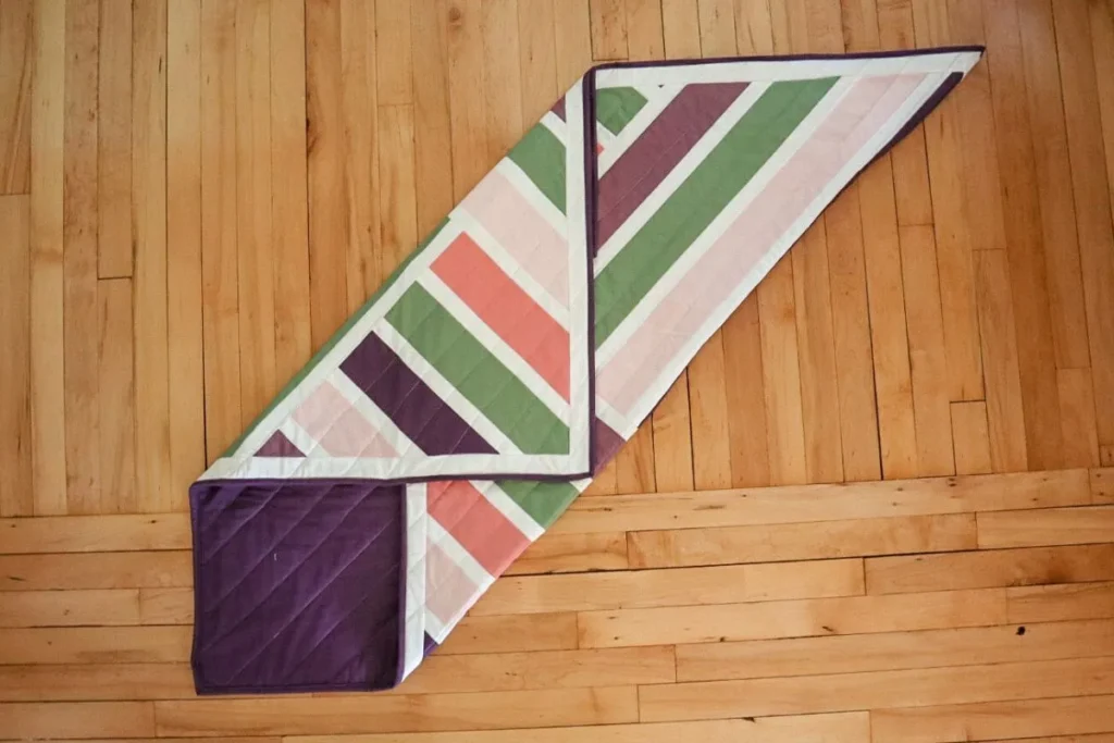 a quilt partially folded on the bias.