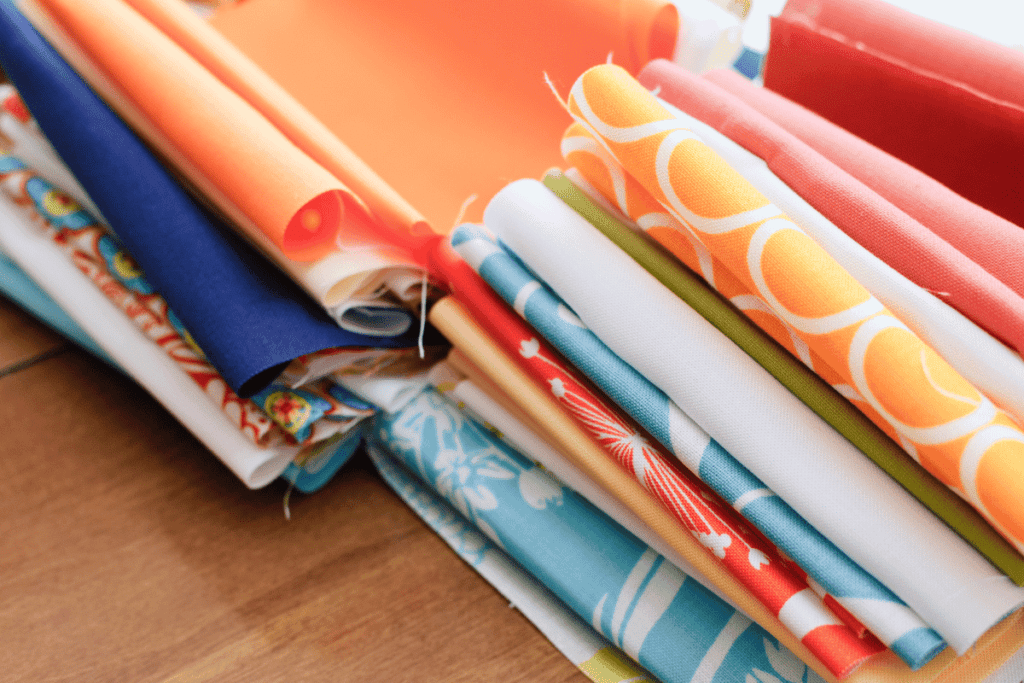 Fat eighth cuts of fabric in a stack.