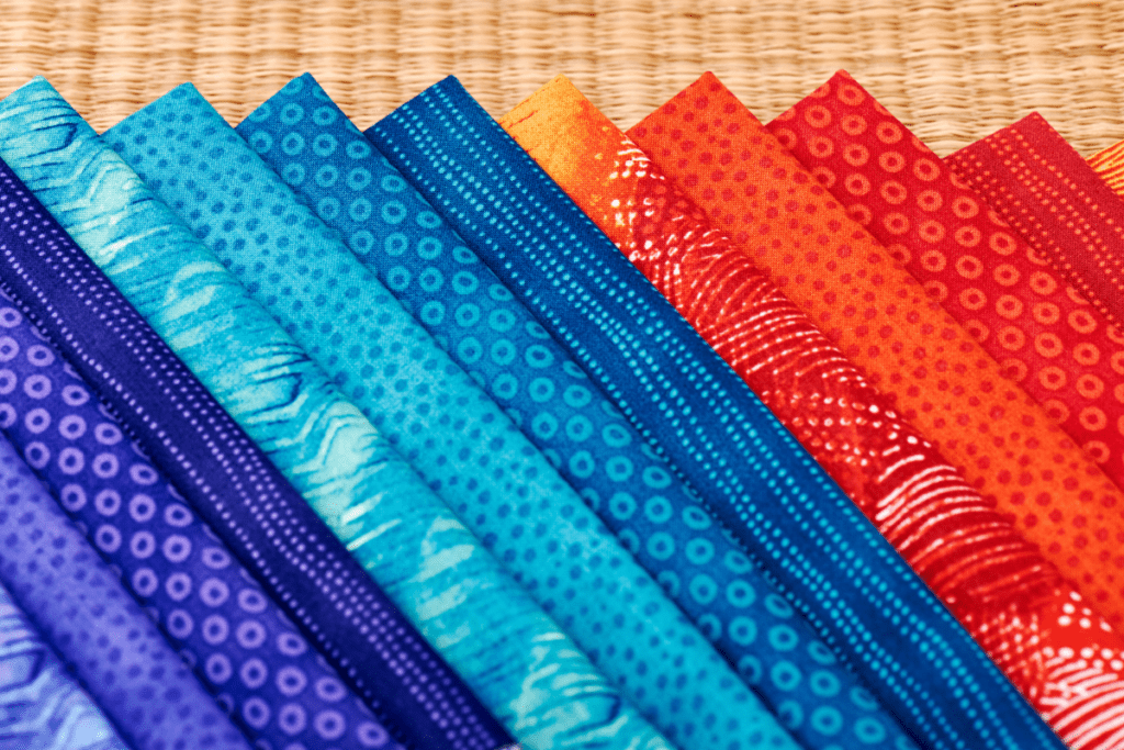 Pueple, blue and red fabric folded and fanned out.